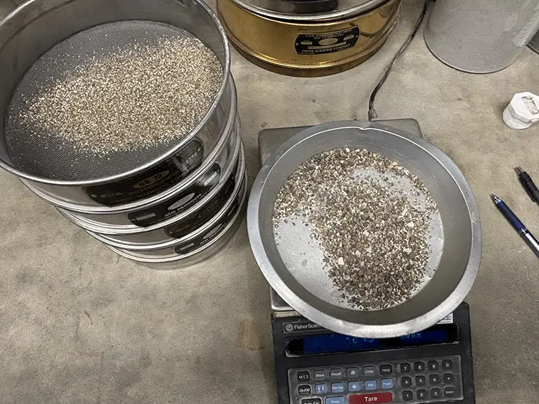 Materials retained on each sieve being weighed to determine the distribution of particle sizes.